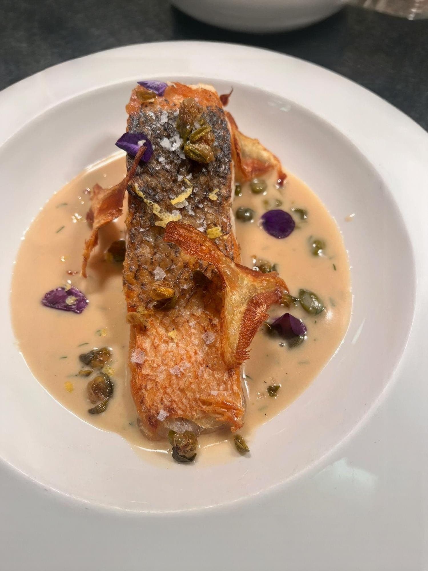 Pan Seared wild Salmon, Lobster Bisque, Fried Capers and Artichoke Chips