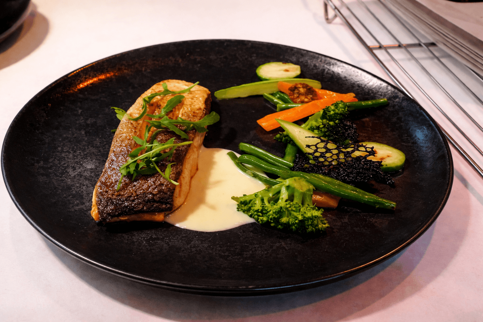 Salmon fillet with lemon butter sauce and sauteed vegetables 