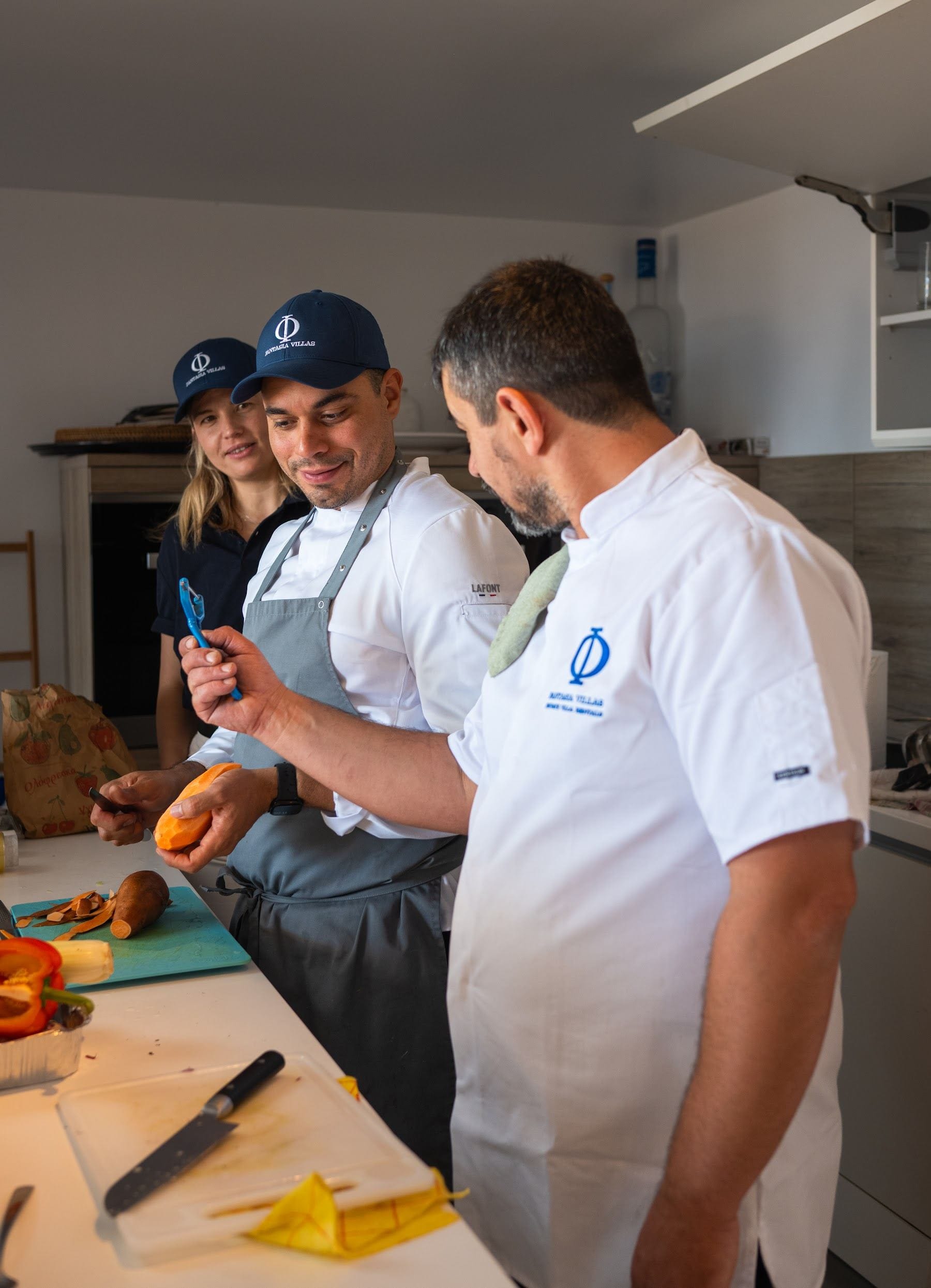 Chef plating at the pass in branded whites