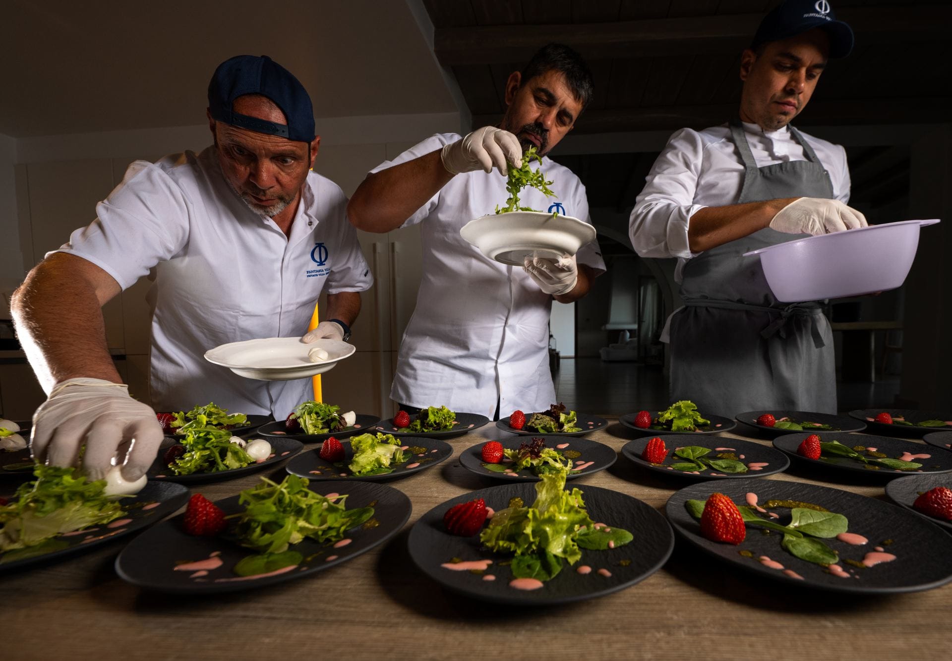 Fantasia Villas private chefs plating fresh salads for guests.