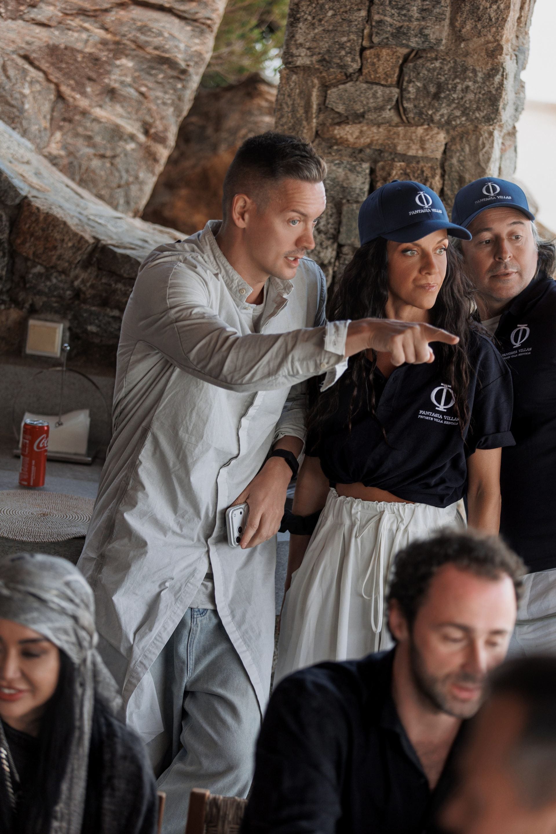 Fantasia Villas team coordinating event details inside a rustic stone villa.