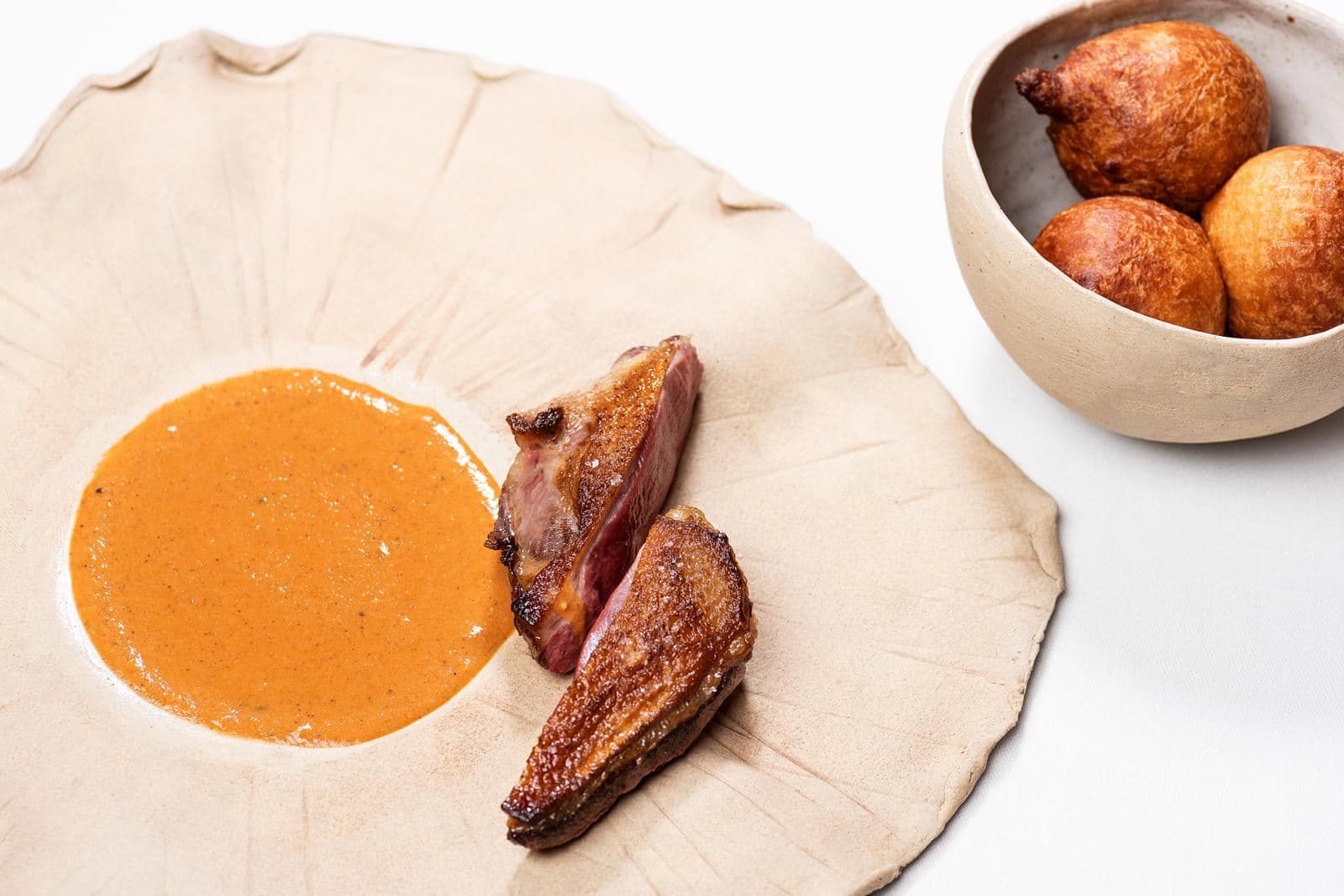 Pigeon with sauce made and puffed donuts